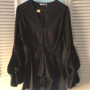 Pretty black balloon sleeve top with cascading ruffle on bottom.